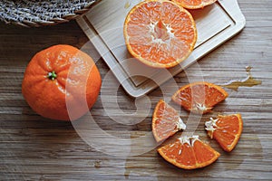 Fresh oranges on wooden table. Oranges in a bowl on wooden table