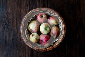 Fresh Organic Apples in wooden basket Dark Moody Background