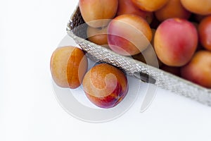 Fresh organic apricot in a fiber open box. on white background. Some apricots photo