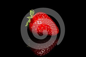 Fresh organic bright red strawberries on a black background. Fresh berry