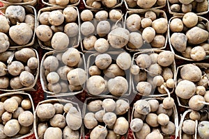 Fresh organic brown unpeeled potatoes on a farmer market