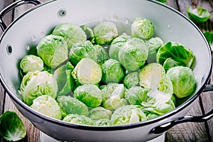 Fresh organic Brussels sprouts in a colander