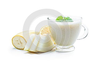 Fresh organic cantaloupe melon and banana smoothie in glass cup isolated on white