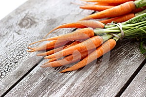 Fresh organic carrots on wooden background, selective focus