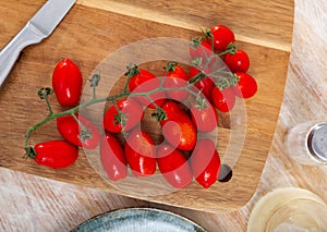 Fresh organic cherry tomatoes on wooden table