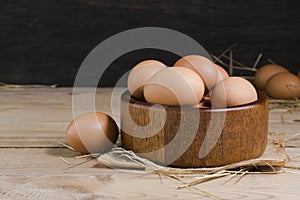 Fresh organic chicken eggs from the farm on a rustic wooden table