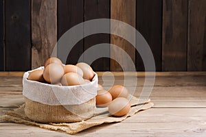 Fresh organic chicken eggs from the farm on a rustic wooden table