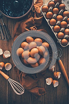 Fresh organic eggs with kitchen and baking utensils