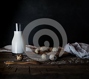 Fresh organic eggs, milk and butter, still life in rustic style, vintage wooden background.