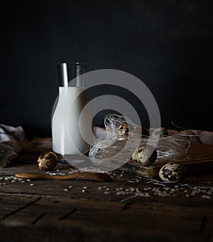 Fresh organic eggs, milk and butter, still life in rustic style, vintage wooden background