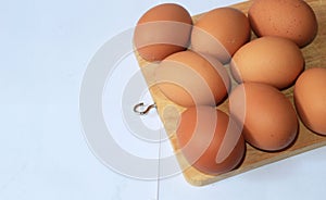 Fresh organic eggs on wood and a white background