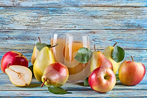 Fresh organic farm pear-apple juice in glass with raw whole sliced pears and apples