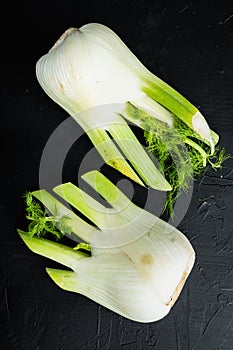 Fresh organic fennel, on black textured background, flat lay