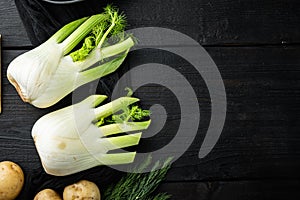 Fresh organic fennel, on black wooden table, top view with space for text