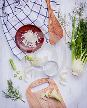 Fresh organic fennel bulbs for culinary purposes on wooden background.