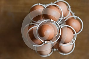 Fresh organic free range eggs in a rack on a wooden background
