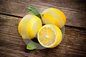 Fresh organic fruit - lemons on wood photo