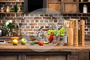 fresh organic fruits and vegetables, digital tablet and wooden kitchen utensils