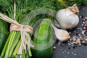 Fresh Organic Garlic, Cucumber, Dill, Coarse Sea and Himalayan Pink Salt, Rainbow Peppercorns on dark