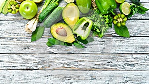 Fresh organic green fruits and vegetables. Avocado, kiwi, onion, lime, parsley. Organic food. Rustic style.