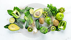 Fresh organic green fruits and vegetables. Avocado, kiwi, onion, lime, parsley. Organic food. Rustic style.