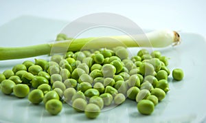 Fresh organic green peas and young onion