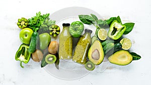 Fresh organic green smoothie on a wooden background. Fresh Green Fruits and Vegetables. Organic food. Rustic style.