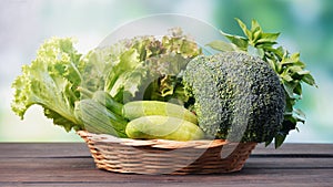 Fresh organic green vegetables in basket on table and blur background, Healthy food concept.