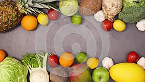 Fresh organic heathy fruits and vegetables appear on top and bottom of dark kitchen table. Stop motion