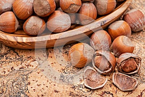 Fresh organic high quality hazelnuts, filberts in wooden bowl on natural cork