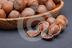 Fresh organic high quality hazelnuts, filberts in wooden bowl on natural stone