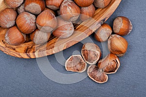 Fresh organic high quality hazelnuts, filberts in wooden bowl on natural stone