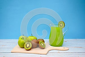 Fresh and organic Kiwi and apples on the tableFresh apples and kiwi with green juice on the table