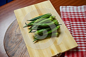 Fresh Organic Lady Finger or Okra Vegetable on Chopper Board