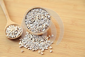 Fresh organic millet or job`s tear seed on sack in bowl  in kitchen for cooking in daily life meal. selective focus. top view