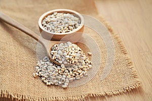 Fresh organic millet or job`s tear seed on sack in bowl  in kitchen for cooking in daily life meal. selective focus. top view