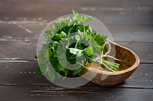 Fresh organic mint bunch in a wooden bowl on the old rustic wooden table.