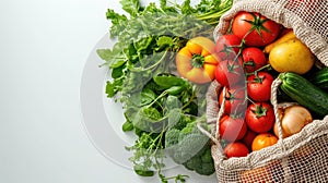 Fresh organic produce in a recyclable paper bag on a white background, concept of sustainable grocery shopping