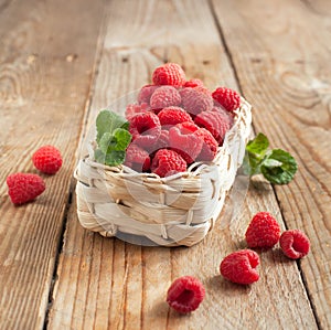 Fresh organic raspberry in basket.