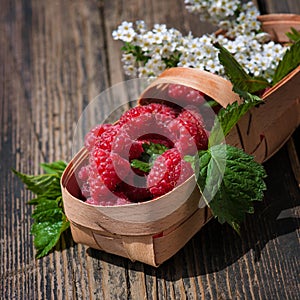 Fresh organic raspberry in basket.