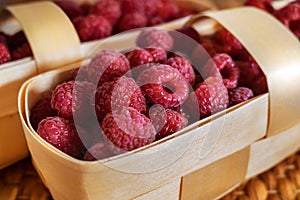 Fresh organic raspberry in basket. Selective focus.