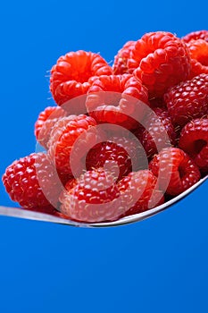 Fresh organic raspberry on a metal spoon