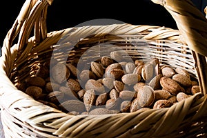 Fresh Organic Raw Almonds with Shell in Basket.