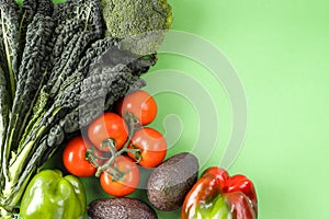 Fresh organic raw vegetables on green background. Diet, detox and healthy food concept, top view flat lay of ingredients
