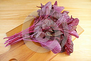 Fresh Organic Red Spinach or Amaranthus Dubius on Wooden Chopping Board