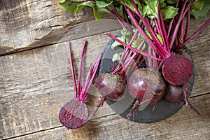 Fresh organic ripe juicy beetroot on a wooden kitchen table. The concept of organic nutrition and autumn harvesting  vegetables.