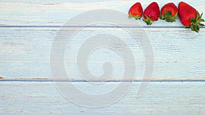 Fresh and organic strawberries appear on top of wooden table - Stop motion