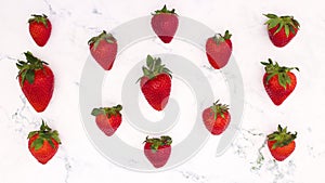 Fresh and organic strawberries changing on marble background - Stop motion