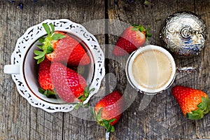 Fresh organic strawberries and traditional turkish coffee on wooden background