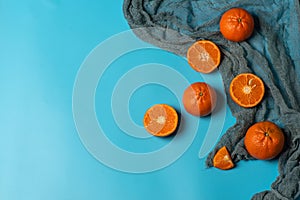 Fresh, organic tangerines on a blue background